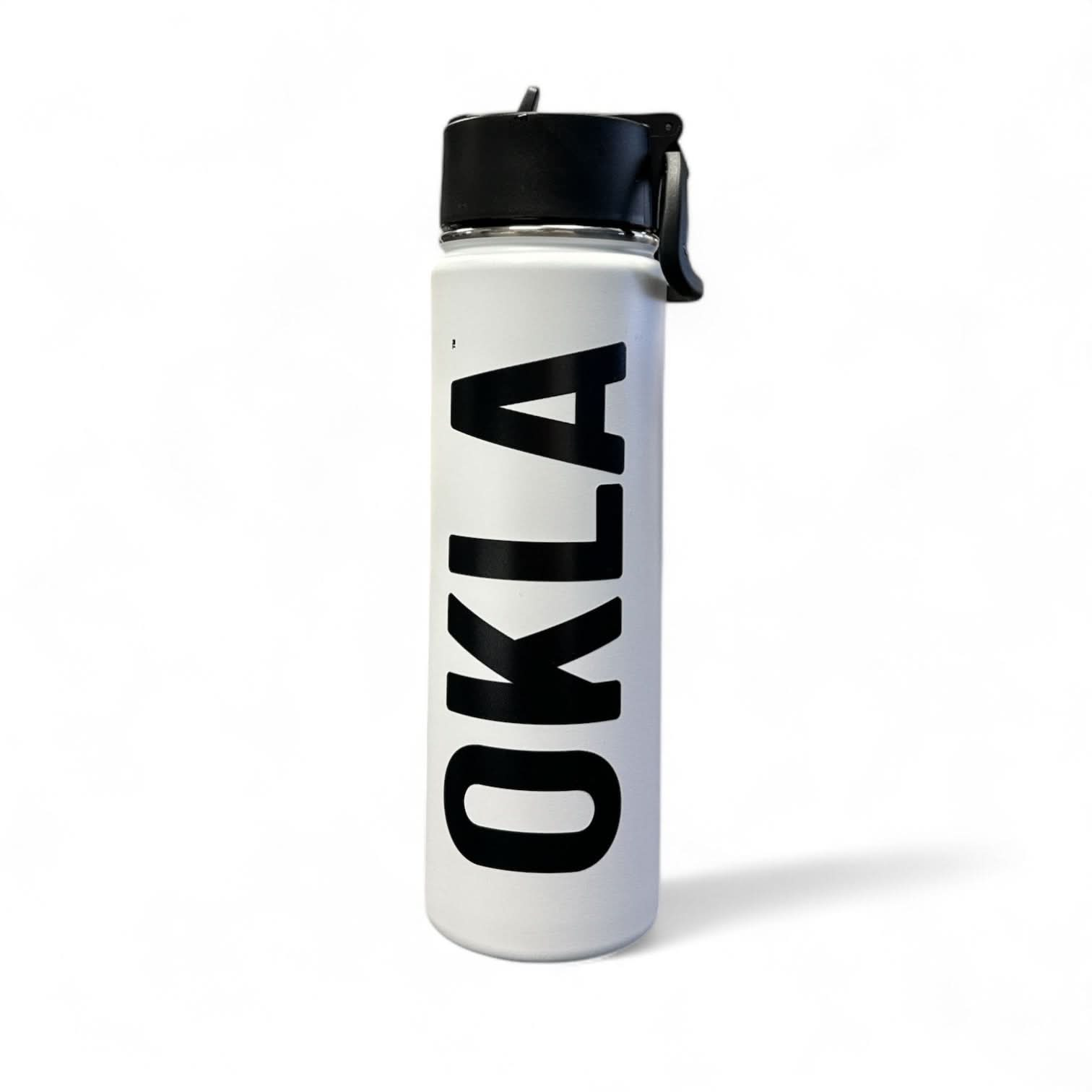 The OKLA - Travel Thermos 22oz is a sleek, stainless steel white water bottle with a leak-proof black lid. It showcases the word "OKLA" in bold black letters vertically and stands upright on a white background, ready for any adventure.