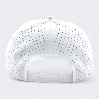 A white OKLA Navigator Hat with perforated holes is displayed from the back, highlighting its adjustable strap with snap closures for personalized sizing. Set against a light grey background, this hat features vintage-inspired 3D patch detailing and incorporates sweat-wicking technology for enhanced comfort.