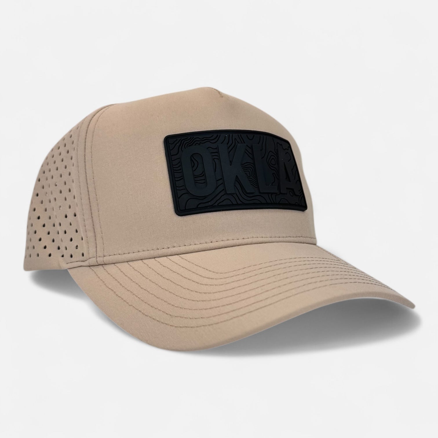 Introducing the OKLA Navigator Hat in beige, showcasing a vintage-inspired 3D patch with "OKLA" on the front. This cap effortlessly combines style and functionality with sweat-wicking technology and side perforations for optimal ventilation.