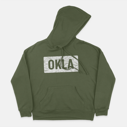 The OKLA Navigator BOLD Hoodie, made from recycled cotton, provides a comfortable unisex fit. This hunter green hoodie is adorned with a patterned rectangular patch on the chest showcasing "OKLA" in bold letters and is enhanced by a front pocket and drawstring hood.