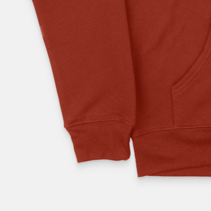A detailed view of the lower section of a rust-colored OKLA Navigator BOLD Hoodie emphasizes the sleeve and kangaroo pocket. Made from recycled cotton, the material looks soft with a subtle texture. The image showcases the hoodie’s comfortable unisex fit along with its intricate stitching and fabric details.