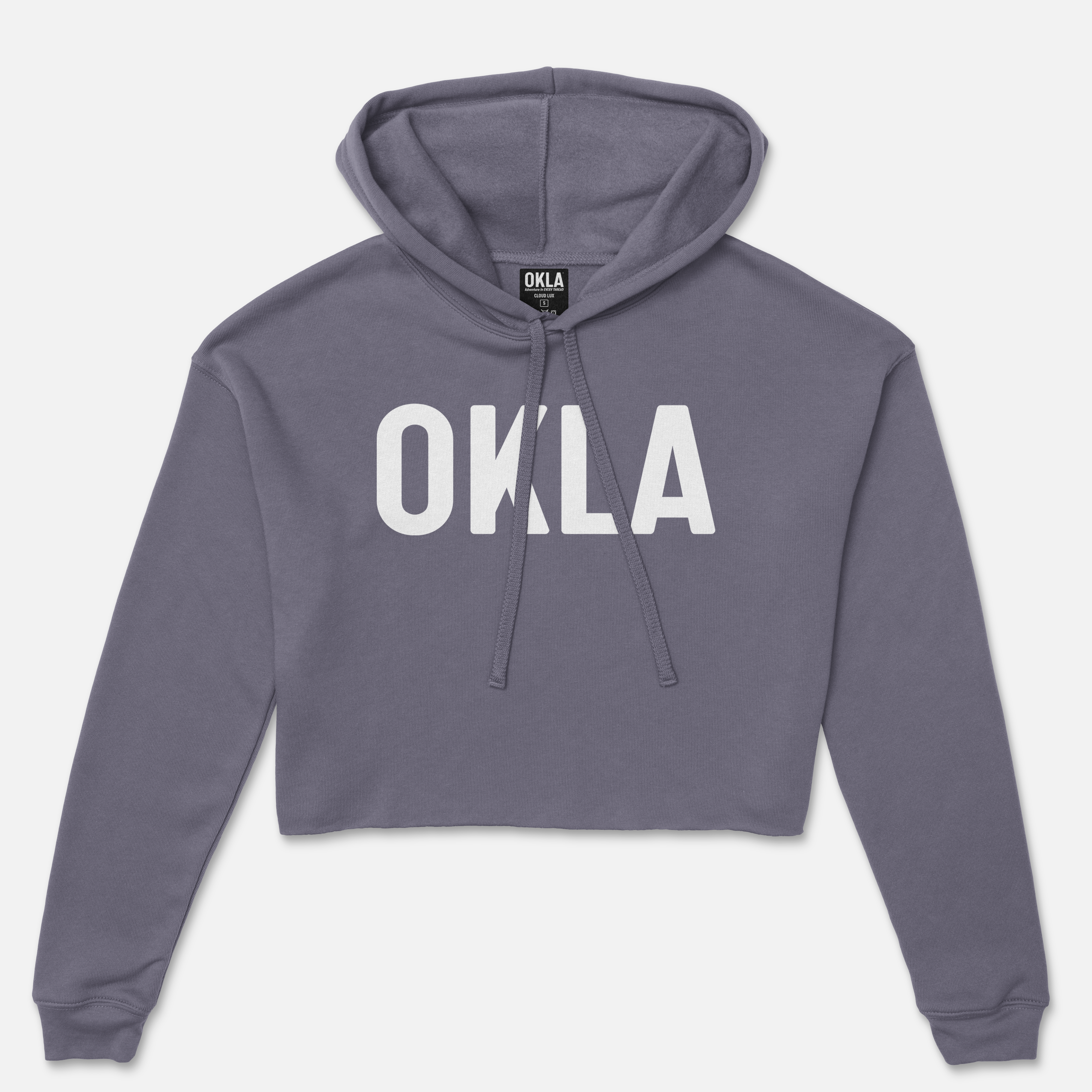 The OKLA Original Crop Hoodie is a modern dark gray cropped hoodie showcasing the prominent OKLA print in large white letters on the chest. It features a drawstring hood and long sleeves, made from cozy fleece fabric, and is set against a white background.