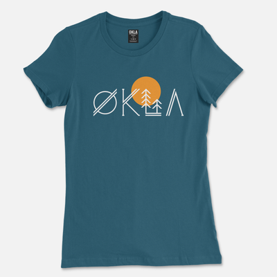 The OKLA Native Tee in blue showcases a stylized design spelling "OKLA" with geometric shapes, where the 'O' resembles the Scandinavian letter Ø. The 'K' is beautifully crafted with a sun and tree motif, featuring a vibrant orange circle representing the sun. Made from recycled cotton, it's perfect for your next adventure.