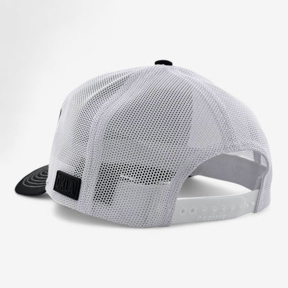 The OKLA Freedom Trucker Hat is presented from a rear angle, highlighting its white mesh build complemented by a black front brim. It includes an adjustable strap for a tailored fit and displays a small black logo patch on the side. Additionally, its sweat-wicking technology guarantees comfort, all set against a simple white backdrop.