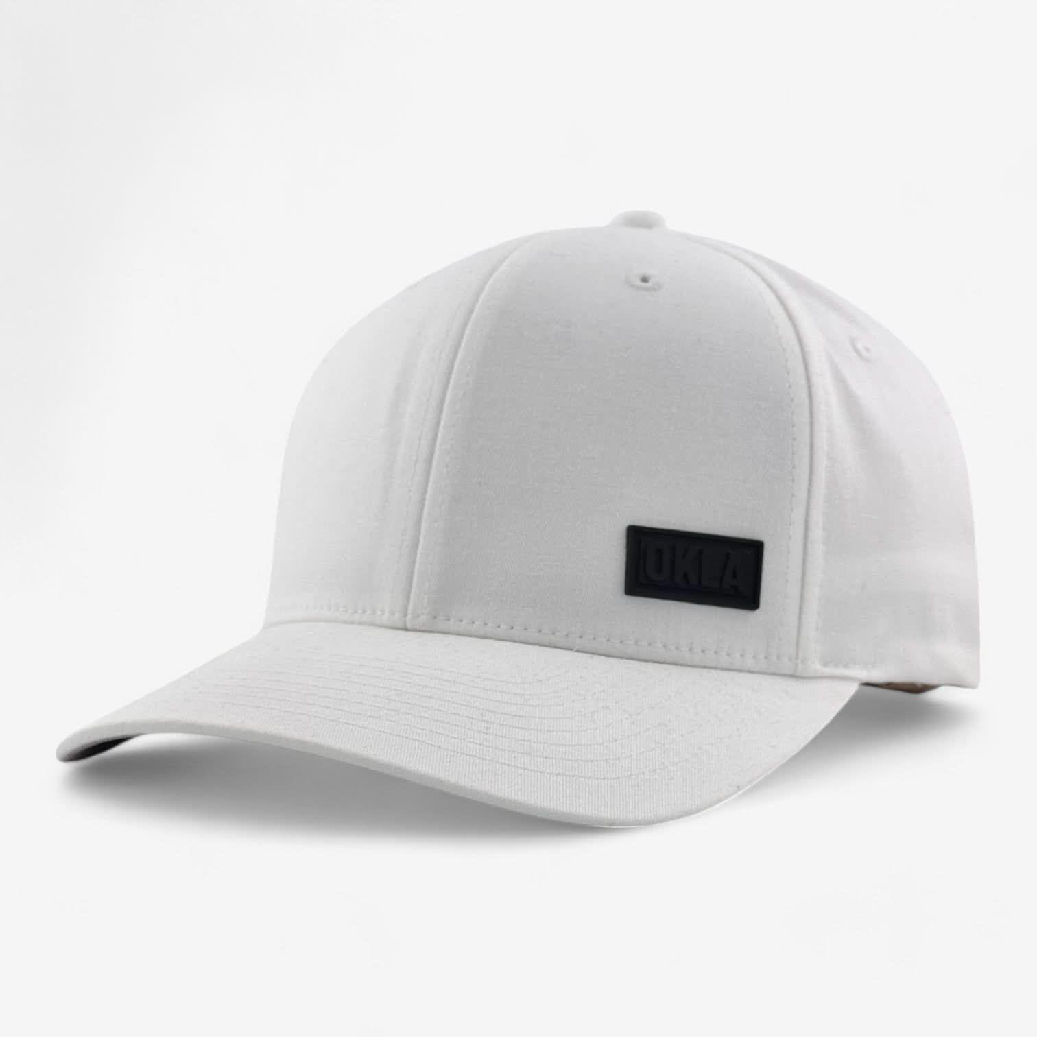 The OKLA Modern White Hat is a stylish white baseball cap featuring a black rectangular patch with the letters "OKLA" on the front. It boasts an athletic shape with a curved brim and a six-panel design, while the elastic stretch band provides a comfortable fit against its plain white background.