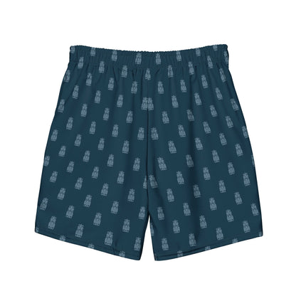 These Tiki Boardshorts feature a dark blue color with an elastic waistband and showcase a repeating pattern of small, light blue architectural structures. The island-inspired prints and quick-dry fabric ensure comfort both in and out of the water.