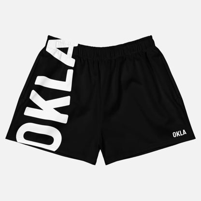 The OKLA - Women’s Shorts in black showcase an elastic waistband and prominently display the white OKLA logo on the left side, with a smaller version at the bottom right. Made from moisture-wicking fabric, they provide UPF50+ protection to ensure both comfort and style.