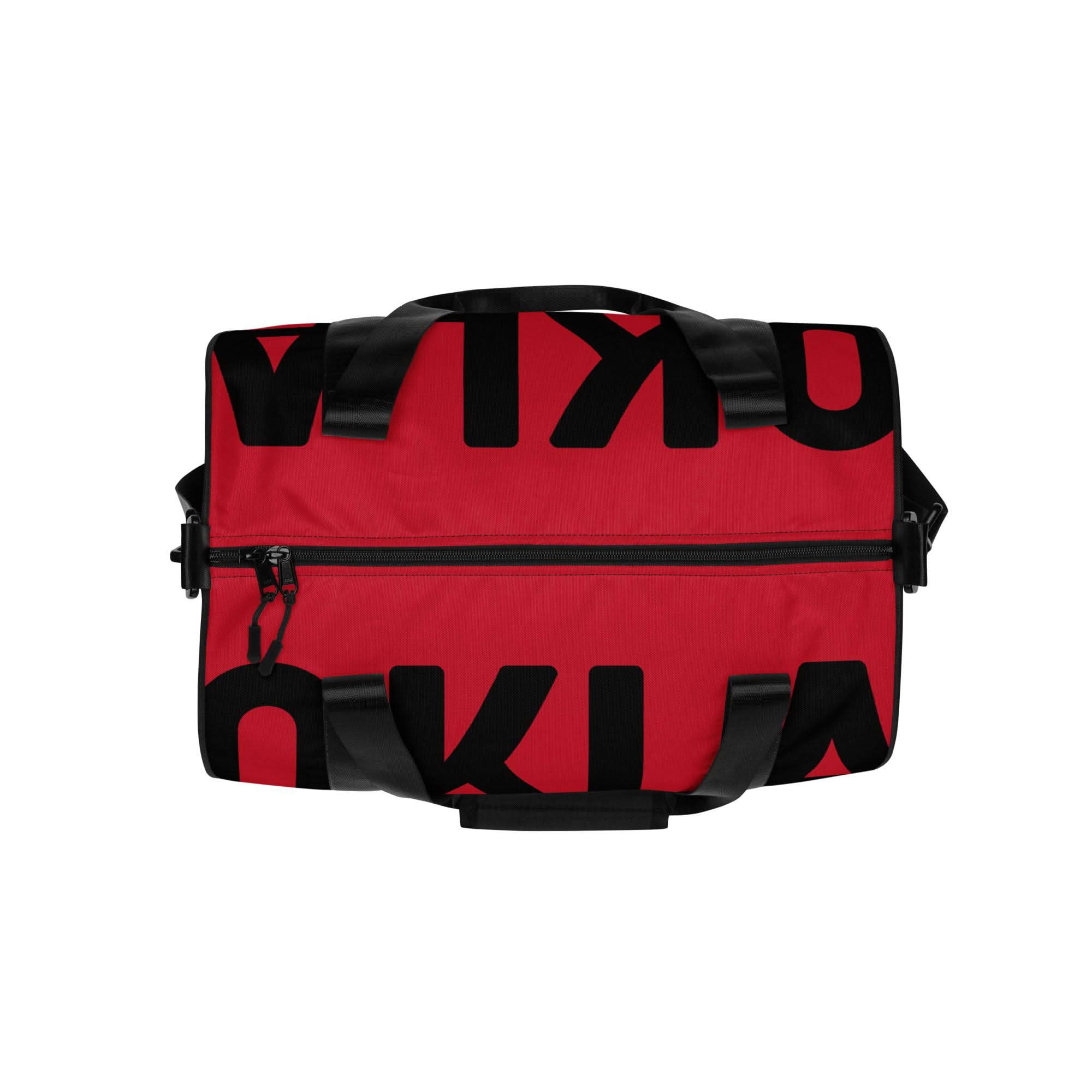 Introducing "The OKLA - Gym Bag Red Series": This durable, water-resistant rectangular gym bag comes in a striking red color with partially visible bold black letters. It features two black handles, a front zipper pocket for convenient storage, and an adjustable shoulder strap for easy carrying.