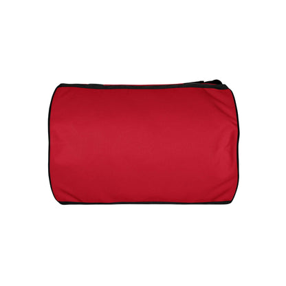 The OKLA - Gym Bag Red Series is showcased against a white background, featuring a rectangular shape with black straps and trim. Constructed from durable fabric, this water-resistant bag offers a simple, sleek design ideal for everyday use.