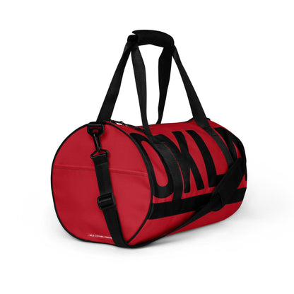 Introducing The OKLA - Gym Bag Red Series: This vibrant bag boasts a bold red exterior with sleek black straps and prominent black lettering on the side. Its cylindrical shape includes a convenient shoulder strap, dual handle straps, and is made from durable, water-resistant fabric for long-lasting use.