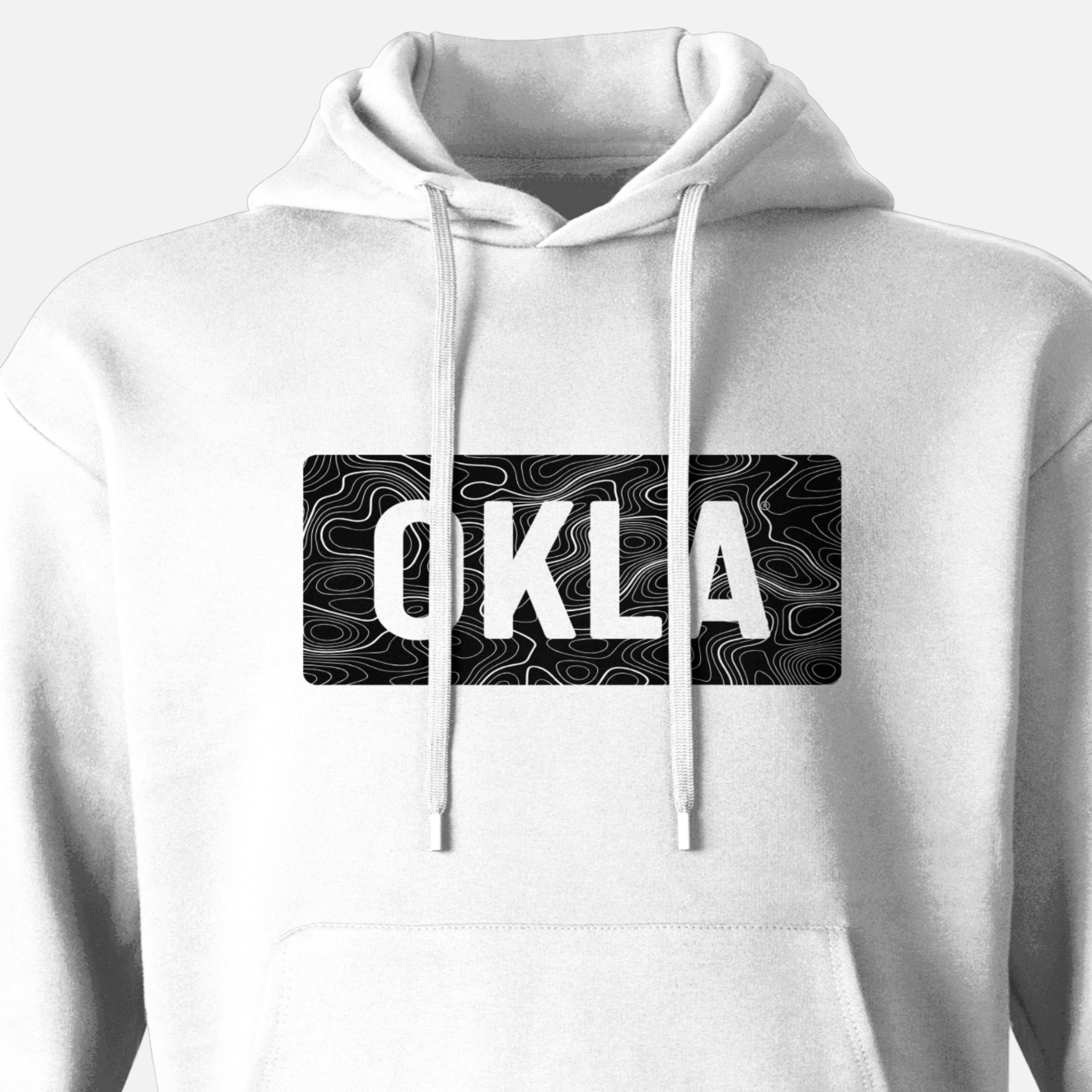 The OKLA Navigator BOLD Hoodie seamlessly blends adventure with comfort, crafted from white, recycled cotton fabric. It boasts a bold black rectangular chest design with prominent "OKLA" lettering over subtle wavy lines that evoke the look of a topographic map and includes convenient drawstrings.