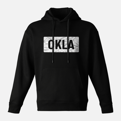 Experience adventure comfort with the OKLA Navigator BOLD Hoodie. Crafted from recycled cotton, this black hoodie is equipped with a front pocket and adjustable drawstring hood. The chest is adorned with a white rectangular design featuring intricate patterns and the letters OKLA in bold black font.